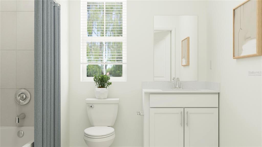 4249 Curacao Place Kissimmee, FL 34758 - Photo 8 of 30 a bathroom with a toilet a sink and a mirror