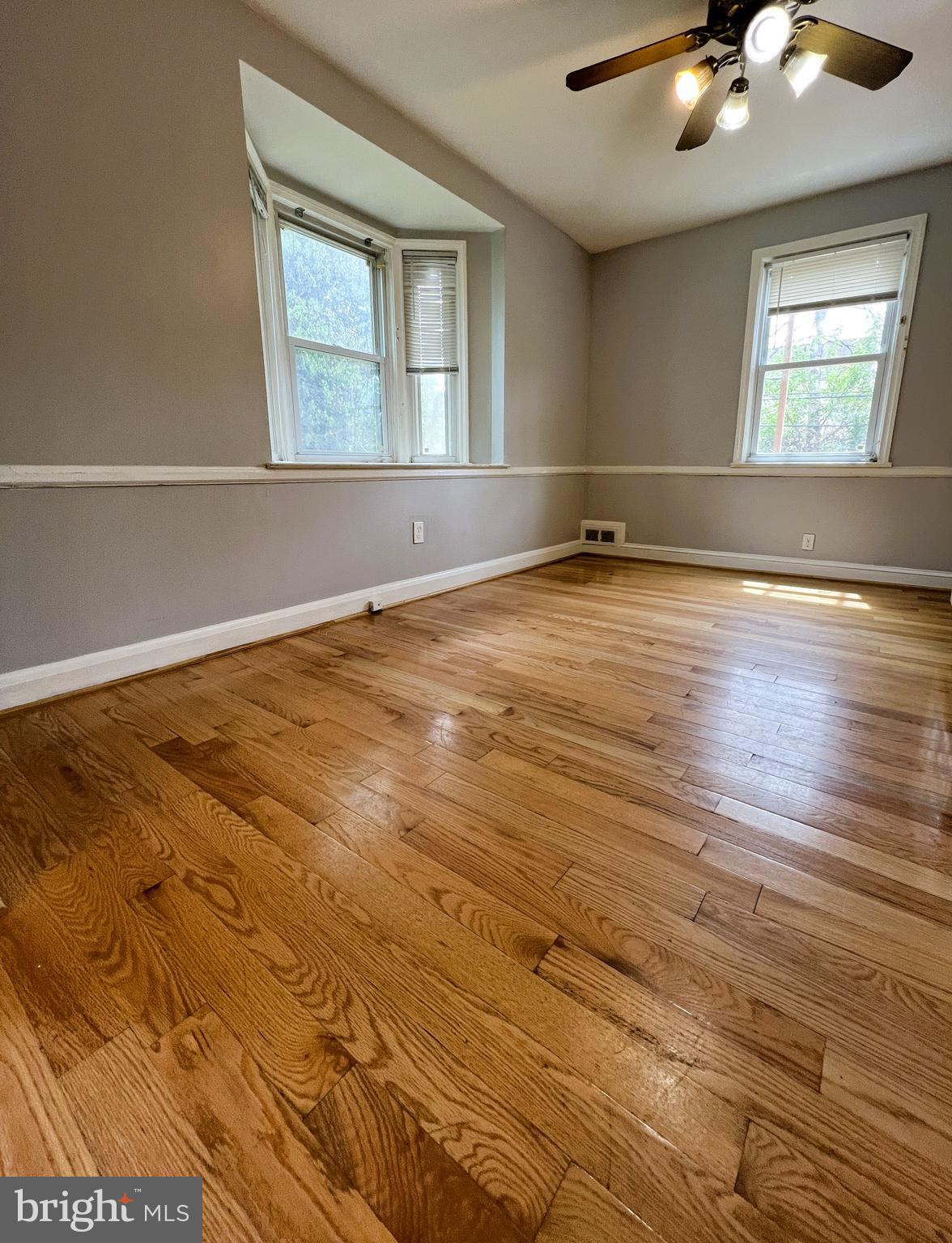 3705 Bancroft Road Baltimore, MD 21215 - Photo 21 of 50 an empty room with wooden floor and windows