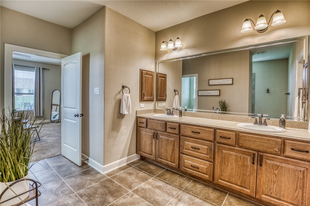 586 Ruby Drive Bellville, TX 77418 - Photo 19 of 50 a spacious bathroom with a granite countertop sink a mirror and a shower