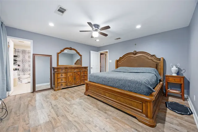 a bedroom with a bed dresser and a window