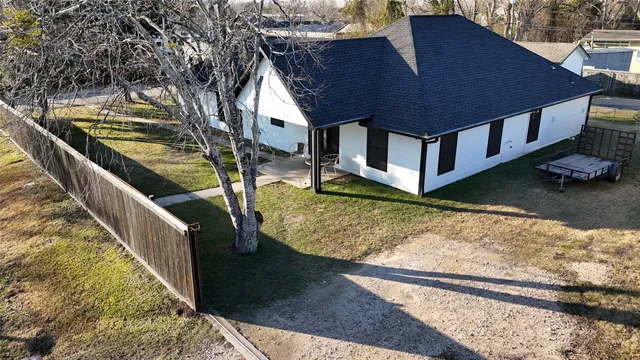 a view of a house with pool yard and wooden fence