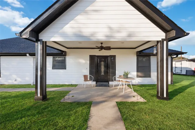 a front view of a house with yard and porch