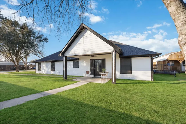 a view of a house with a yard and sitting area