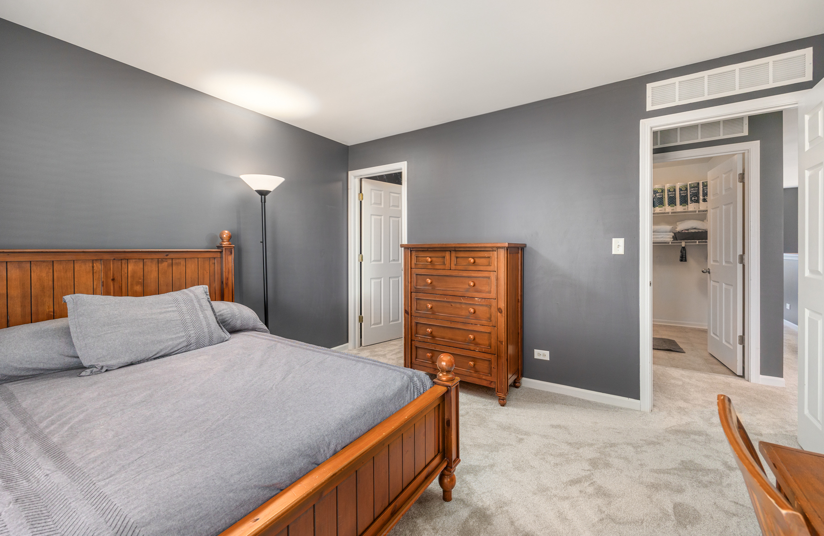 754 Beethoven Street Volo, IL 60073 - Photo 15 of 32 a bedroom with a bed and a dresser in it