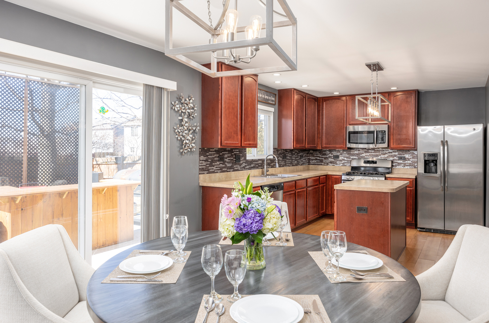 754 Beethoven Street Volo, IL 60073 - Photo 2 of 32 a living room with stainless steel appliances kitchen island granite countertop furniture and a fireplace