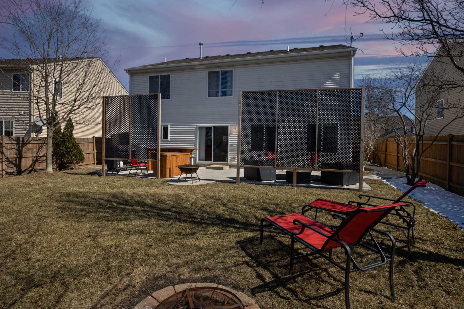 754 Beethoven Street Volo, IL 60073 - Photo 24 of 32 a view of a backyard with table and chairs with wooden fence