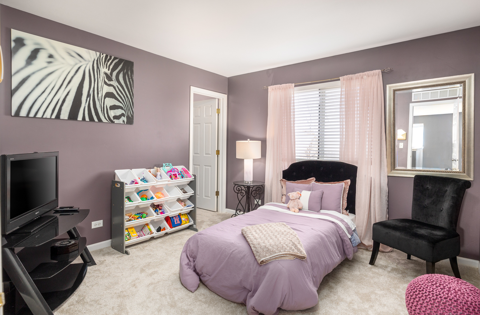 754 Beethoven Street Volo, IL 60073 - Photo 6 of 32 a bedroom with a bed a dresser and a flat screen tv