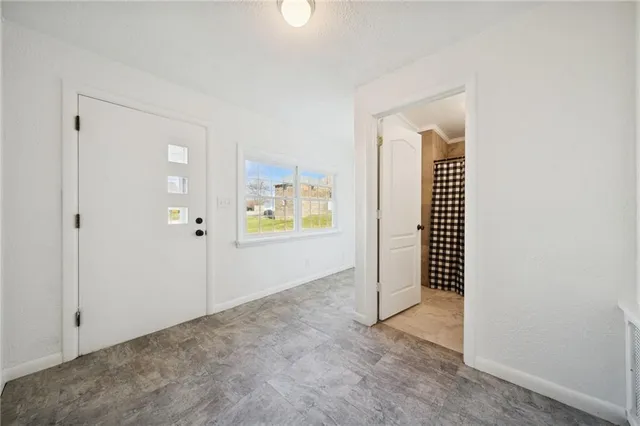 an empty room with closet and dryer