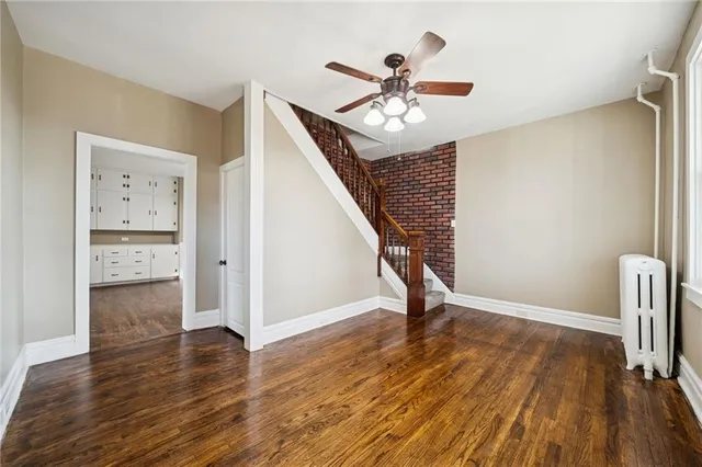 a view of an entryway with wooden floor