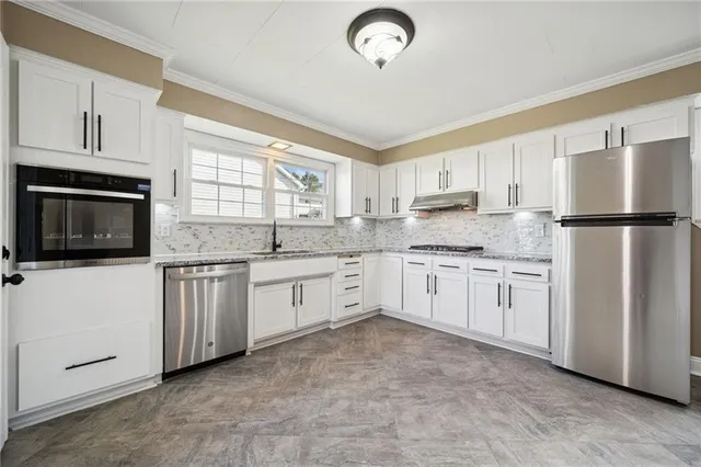 a kitchen with white cabinets and white appliances