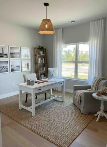 a living room with furniture a window and a table