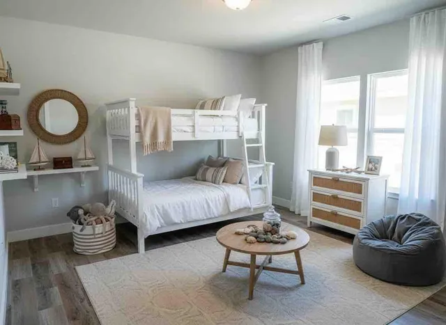 a bedroom with furniture and a wooden floor