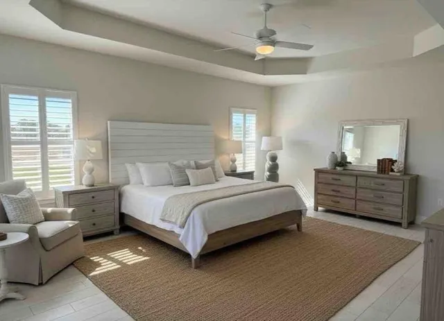 a bedroom with a bed and a chandelier