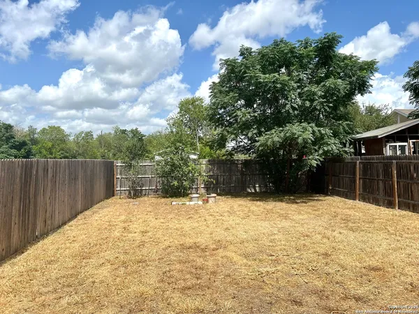 a swimming pool with trees in front of it
