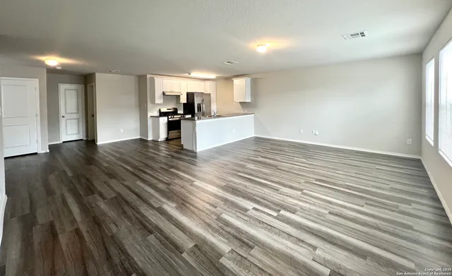 a view of a kitchen with a sink and cabinets