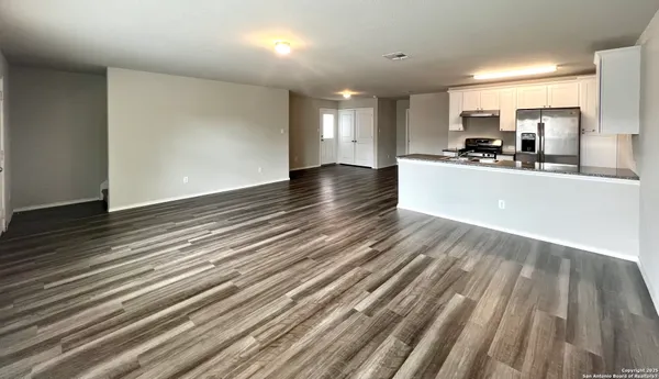 a view of kitchen and sink with wooden floor
