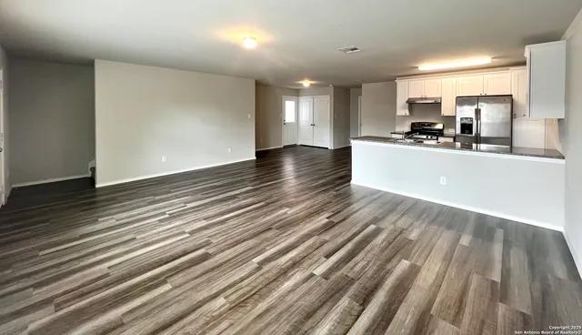 a view of kitchen and sink with wooden floor