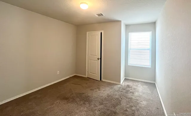 an empty room with closet area