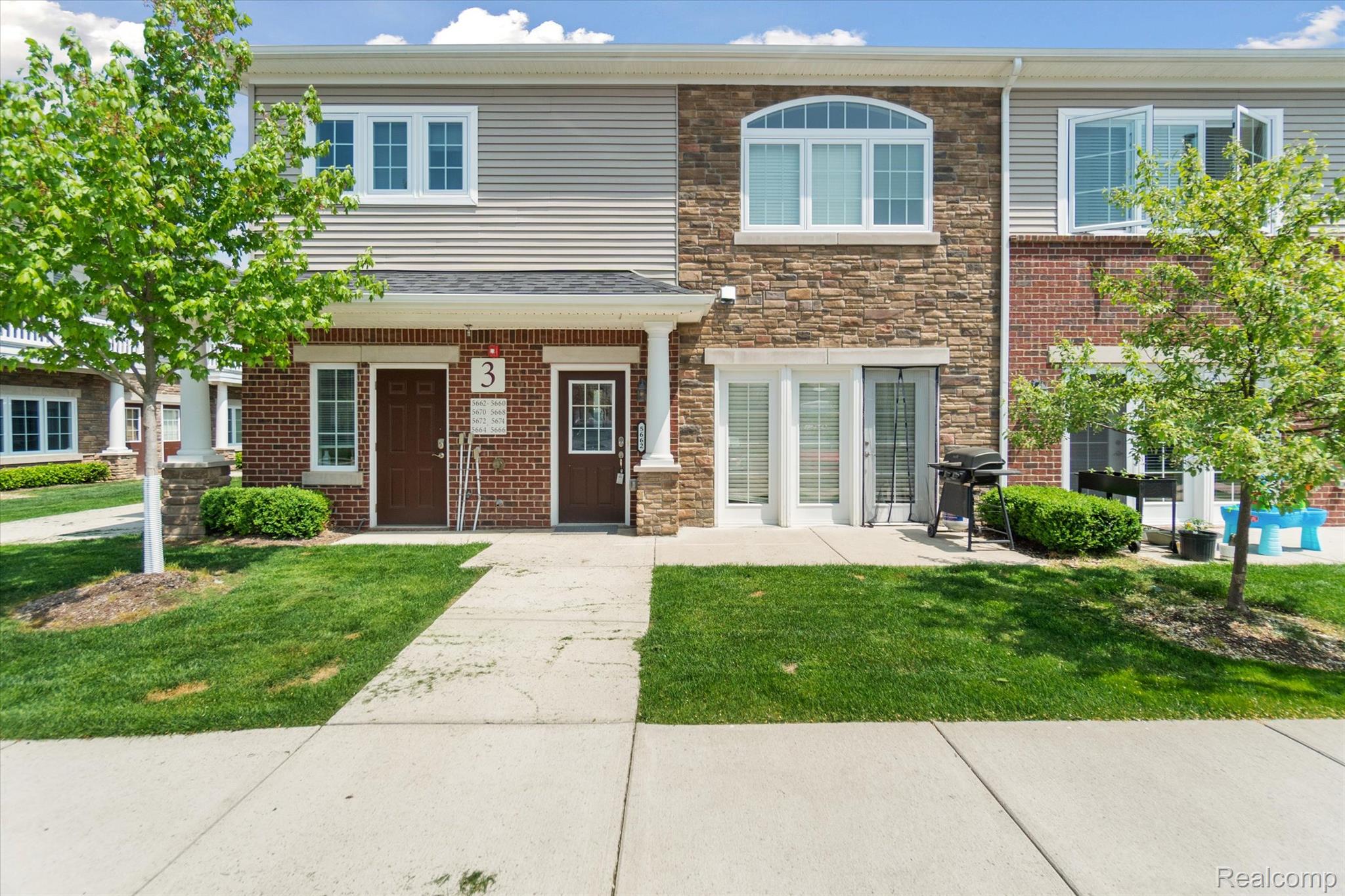 5662 Arbor Chase Drive Ann Arbor, MI 48103 - Photo 27 of 27 Townhome exterior featuring a combination of brick, stone veneer, and siding