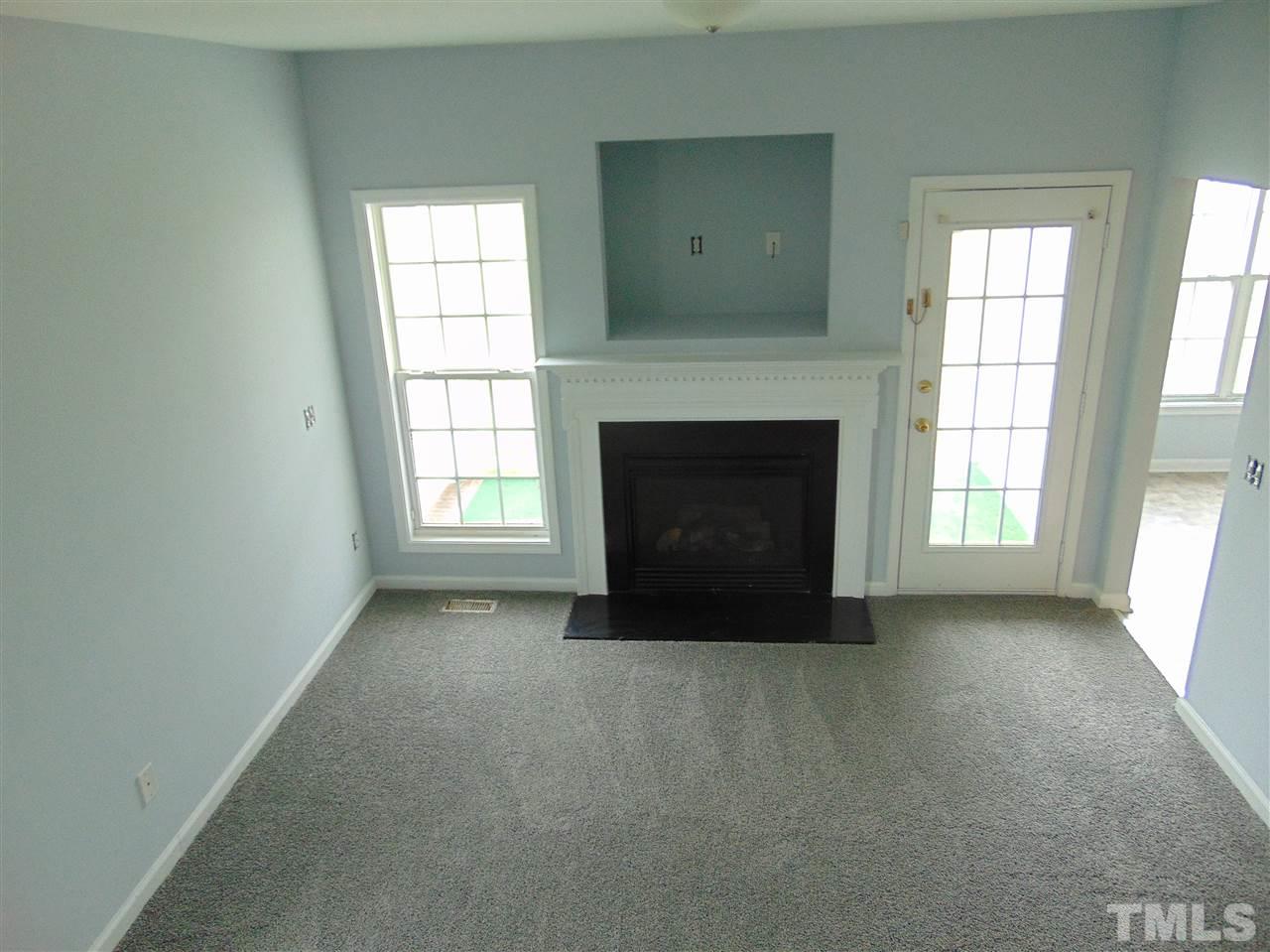 3828 Pin Oak Road Raleigh, NC 27604 - Photo 3 of 10 an empty room with windows and fireplace