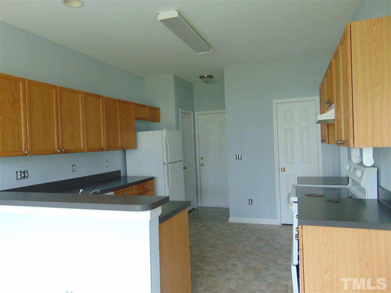 3828 Pin Oak Road Raleigh, NC 27604 - Photo 5 of 10 a kitchen with a sink and a refrigerator