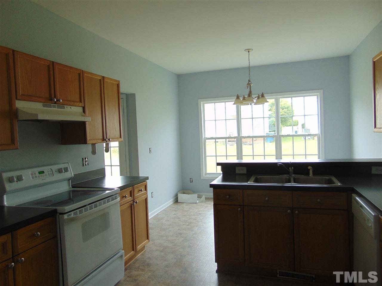 3828 Pin Oak Road Raleigh, NC 27604 - Photo 6 of 10 a kitchen with a sink stove and cabinets