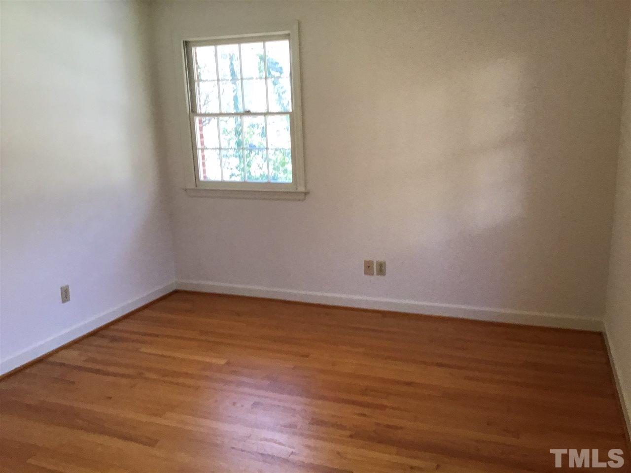 3701 Pembrook Place Raleigh, NC 27612 - Photo 17 of 30 an empty room with wooden floor and windows