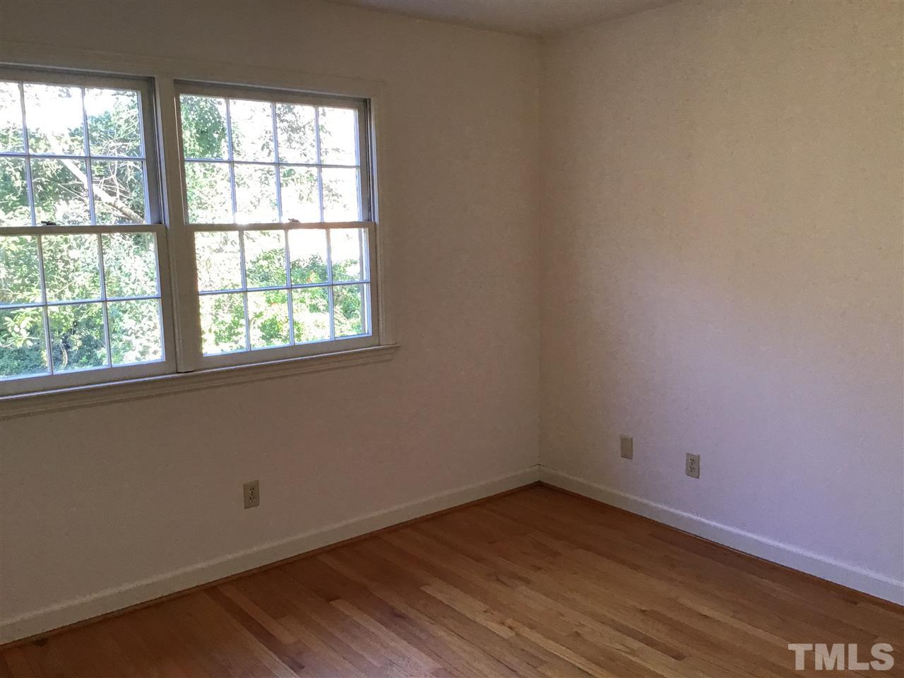 3701 Pembrook Place Raleigh, NC 27612 - Photo 18 of 30 an empty room with wooden floor and windows