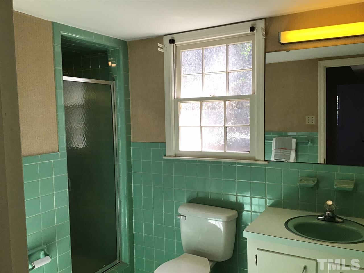 3701 Pembrook Place Raleigh, NC 27612 - Photo 24 of 30 a bathroom with a toilet a sink and window