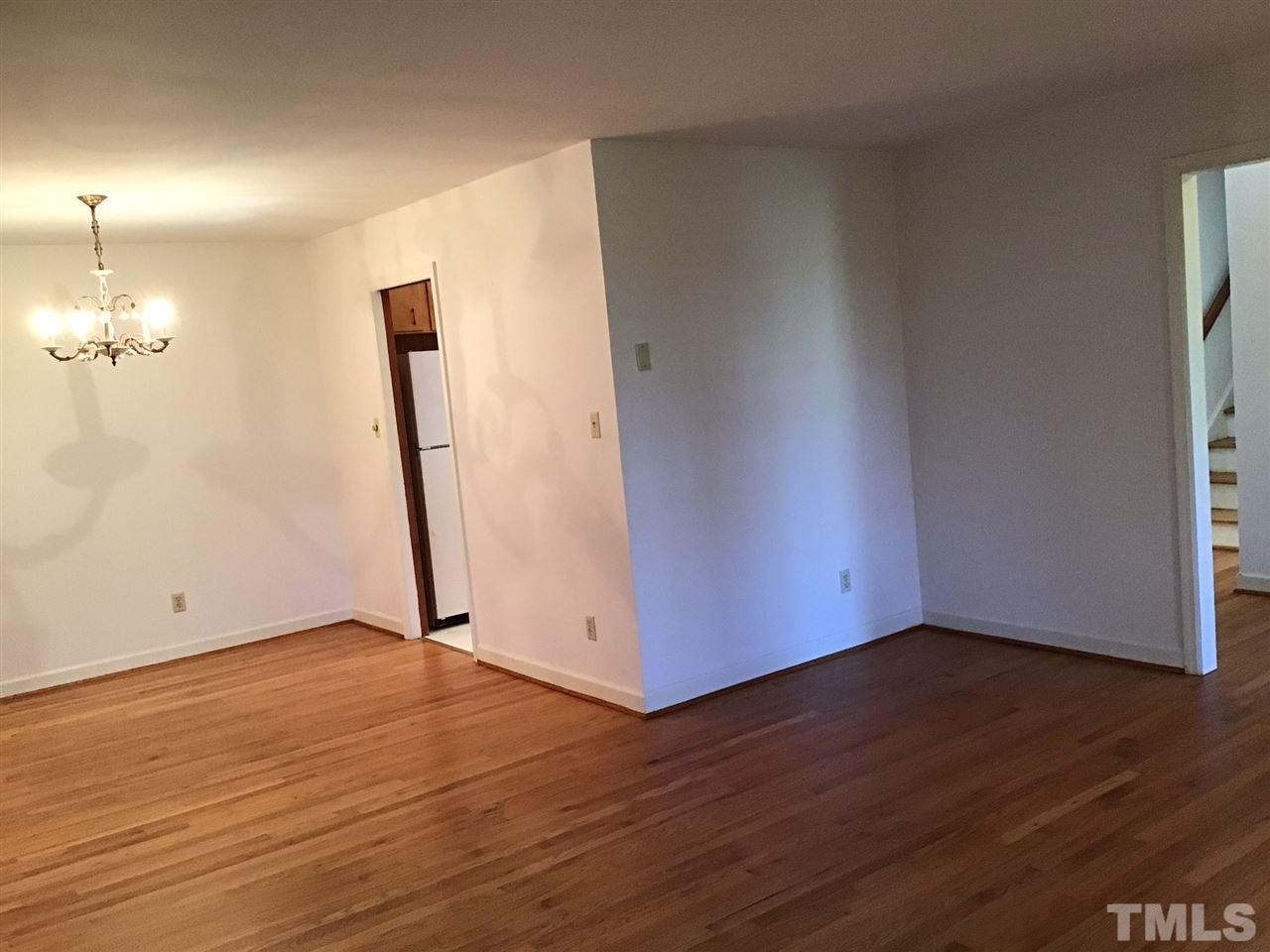 3701 Pembrook Place Raleigh, NC 27612 - Photo 4 of 30 a view of an empty room with wooden floor