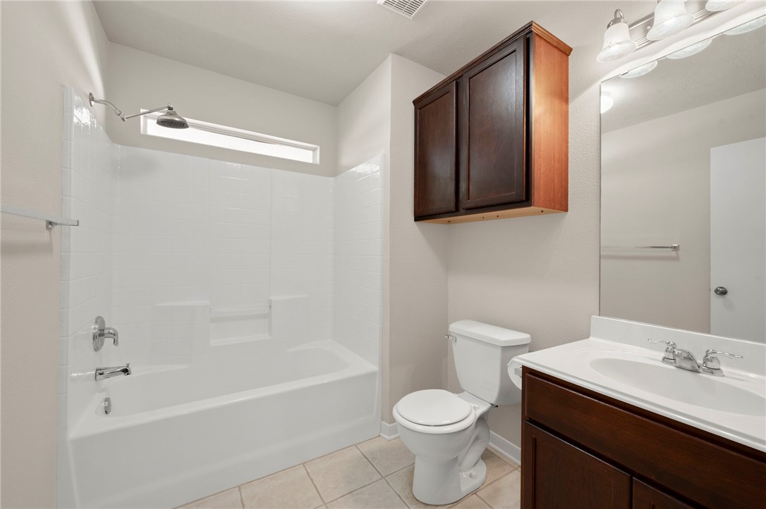 919 Windmeadows Drive College Station, TX 77845 - Photo 11 of 12 a bathroom with a sink a toilet and shower