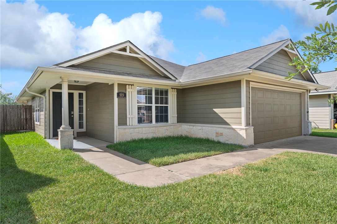 919 Windmeadows Drive College Station, TX 77845 - Photo 2 of 12 a front view of a house with a yard and garage