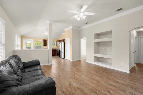 a living room with furniture and a chandelier