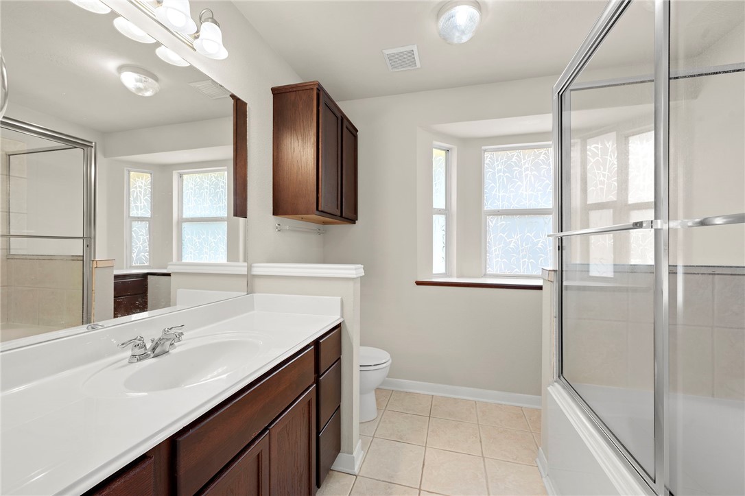 919 Windmeadows Drive College Station, TX 77845 - Photo 8 of 12 a bathroom with a sink a toilet and mirror