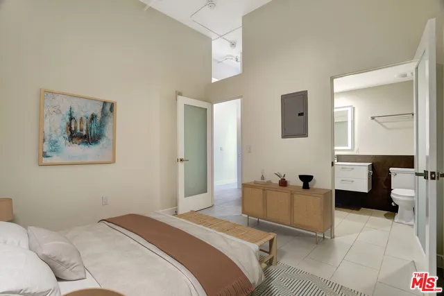 a bedroom with a bed couch and a window