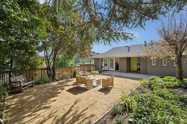 a front view of a house with yard patio and fire pit