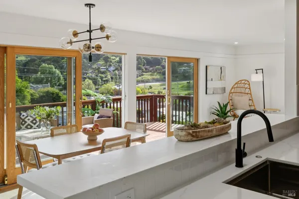 a dining room with furniture water view and a large window