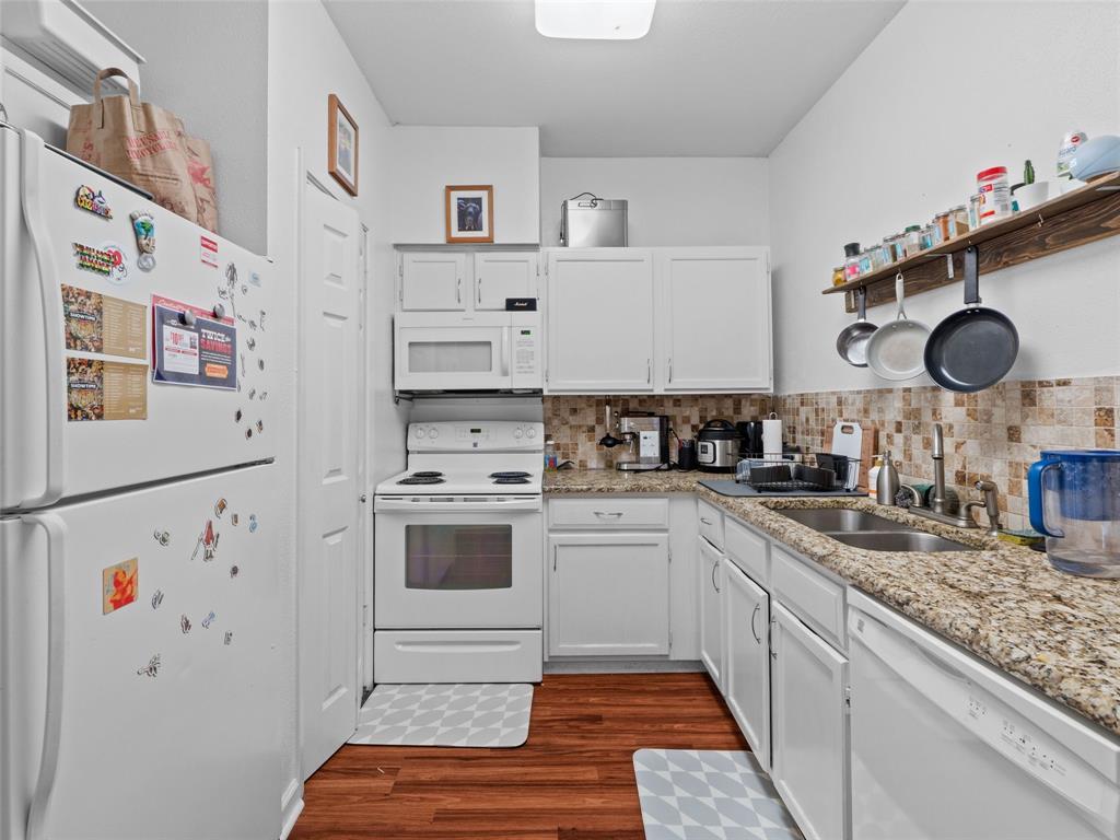 2801 Rio Grande Street, Unit 205 Austin, TX 78705 - Photo 11 of 25 a kitchen with stainless steel appliances granite countertop a sink and a refrigerator