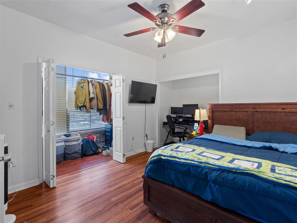 2801 Rio Grande Street, Unit 205 Austin, TX 78705 - Photo 13 of 25 a bedroom with a bed and a flat tv screen on dresser