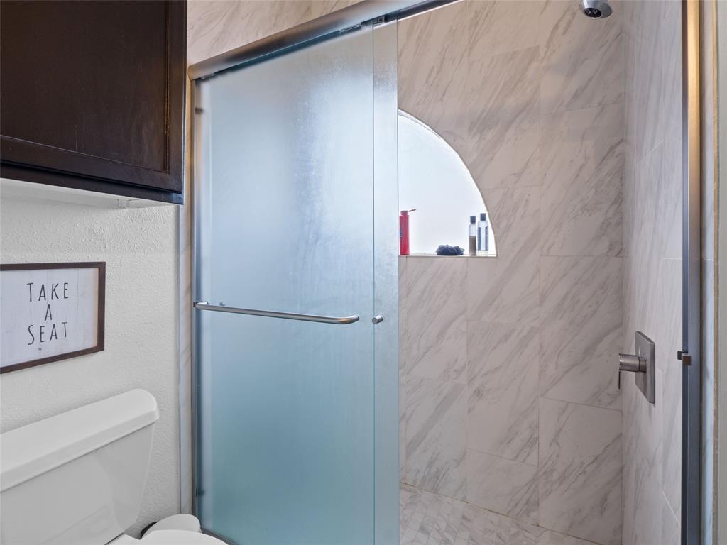 2801 Rio Grande Street, Unit 205 Austin, TX 78705 - Photo 16 of 25 a bathroom with a toilet and a shower