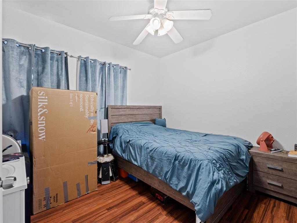 2801 Rio Grande Street, Unit 205 Austin, TX 78705 - Photo 17 of 25 a bedroom with a bed and a chandelier