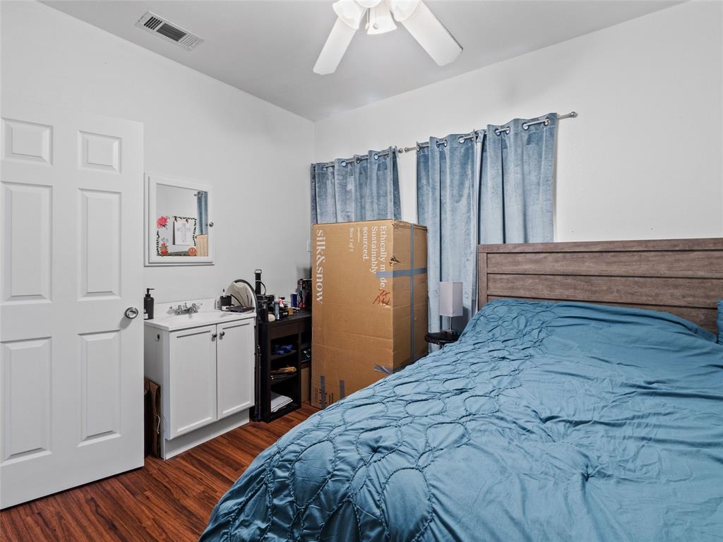2801 Rio Grande Street, Unit 205 Austin, TX 78705 - Photo 19 of 25 a bedroom with a bed and a refrigerator
