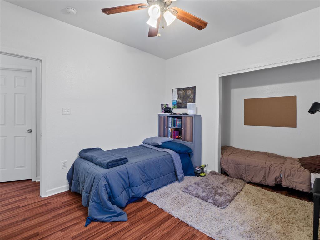 2801 Rio Grande Street, Unit 205 Austin, TX 78705 - Photo 20 of 25 a bedroom with two beds and a chandelier