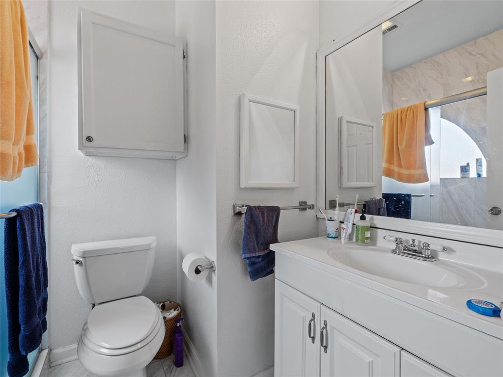 2801 Rio Grande Street, Unit 205 Austin, TX 78705 - Photo 22 of 25 a bathroom with a sink a toilet and a mirror
