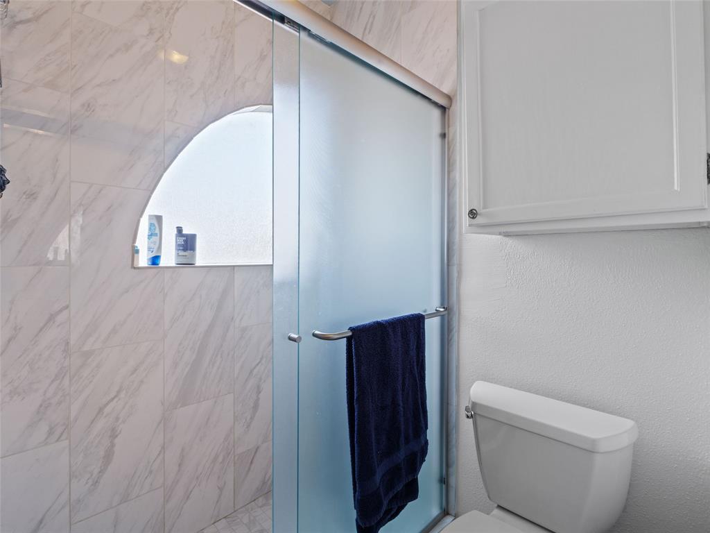 2801 Rio Grande Street, Unit 205 Austin, TX 78705 - Photo 23 of 25 a bathroom with a toilet and a mirror