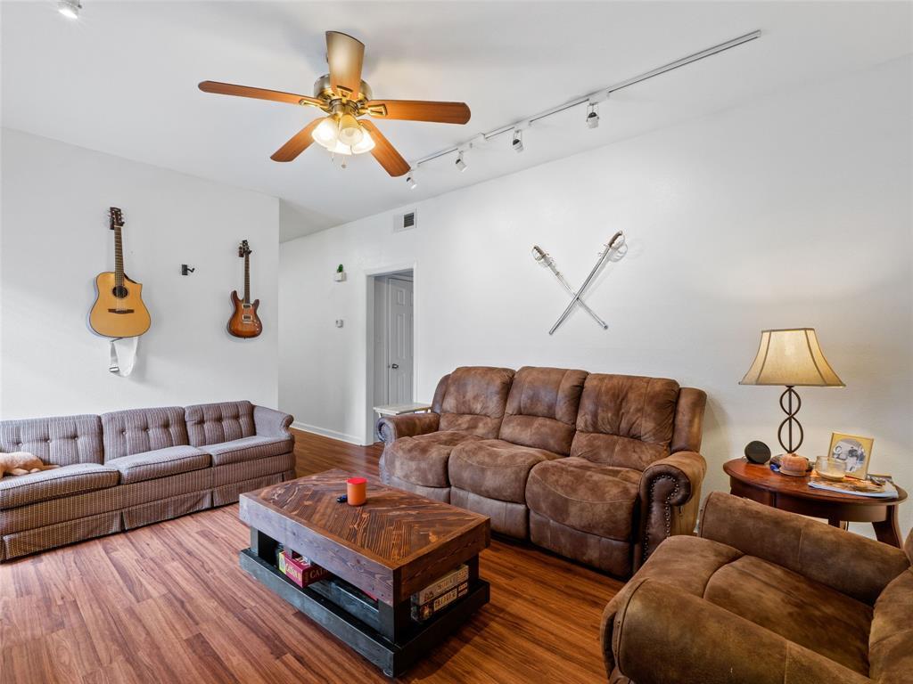 2801 Rio Grande Street, Unit 205 Austin, TX 78705 - Photo 6 of 25 a living room with furniture and a ceiling fan