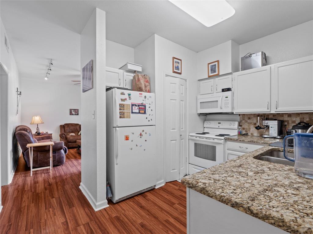 2801 Rio Grande Street, Unit 205 Austin, TX 78705 - Photo 10 of 25 a kitchen with stainless steel appliances granite countertop a refrigerator and stove top oven