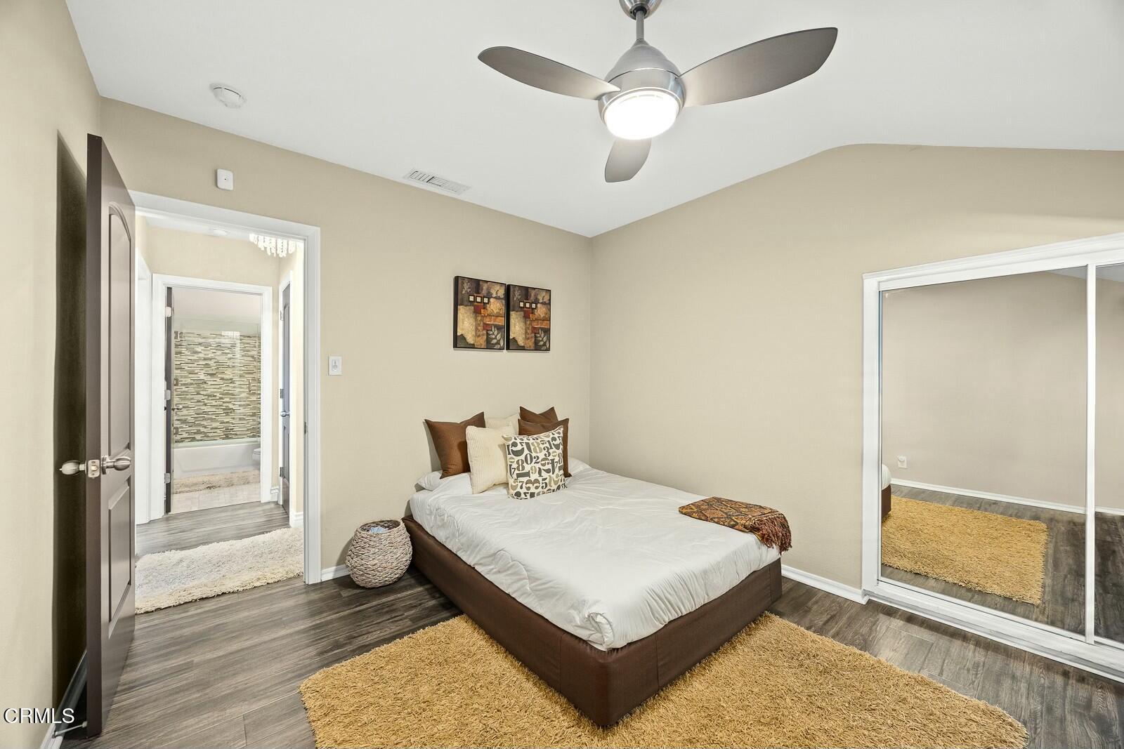 6708 Ranchito Avenue Van Nuys, CA 91405 - Photo 16 of 37 a bedroom with a bed and wooden floor