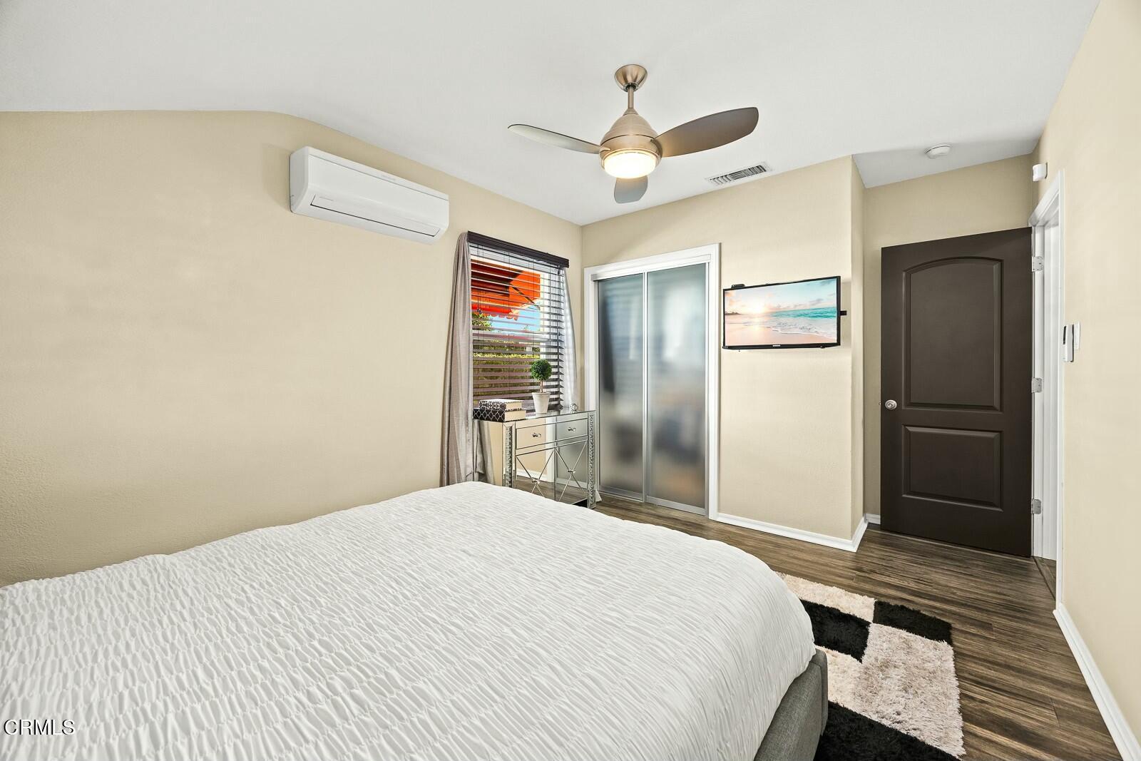 6708 Ranchito Avenue Van Nuys, CA 91405 - Photo 19 of 37 a bedroom with a bed and a refrigerator