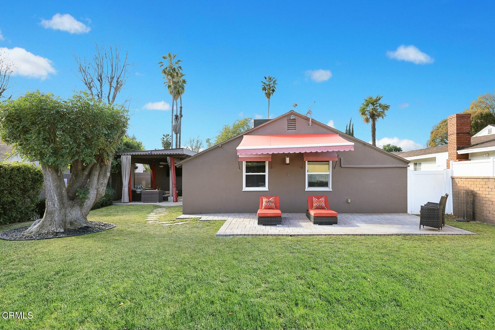 6708 Ranchito Avenue Van Nuys, CA 91405 - Photo 29 of 37 a front view of a house with a yard and trees